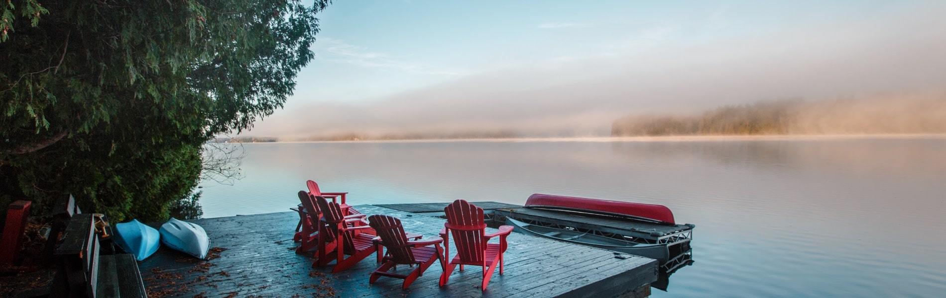 Picture of chairs on dock looking out at beautiful Ontario sunset. 